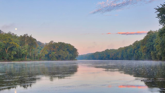 A sunset view next to a river.