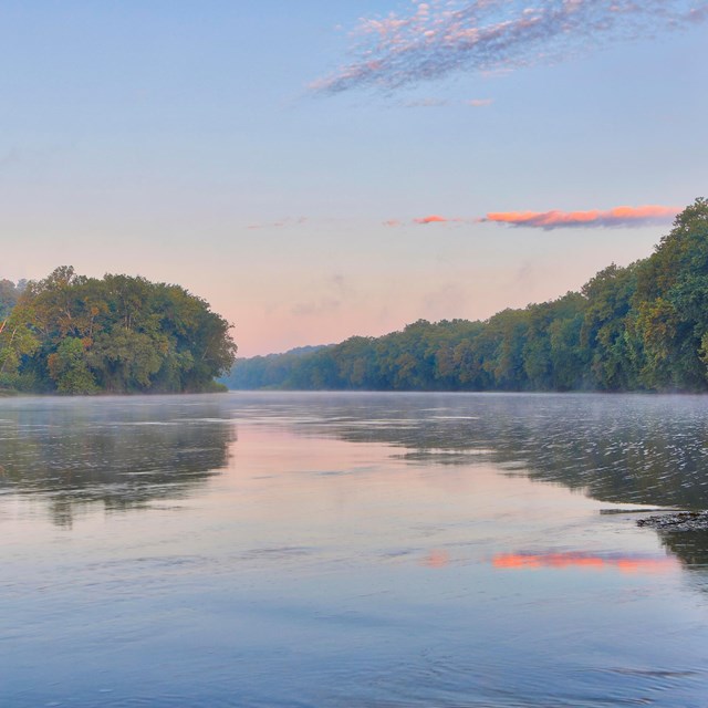 A sunset view next to a river.