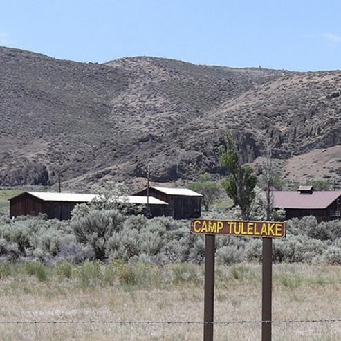 Camp Tulelake sign with various buildings in the background, Tule Lake National Monument