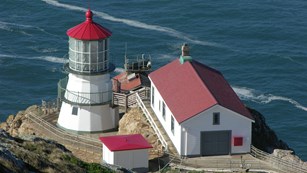 The Point Reyes Lighthouse and associated buildings at the base of 313 stairs.