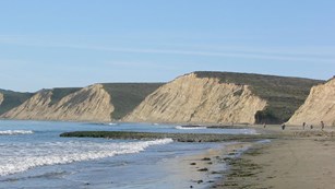 View looking west across a lagoon at the bluffs rising from Drakes Beach.