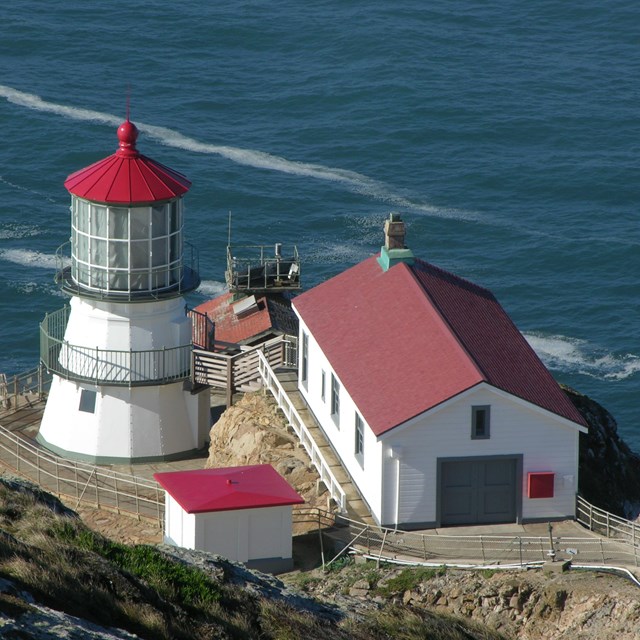 The Point Reyes Lighthouse and associated buildings at the base of 313 stairs.