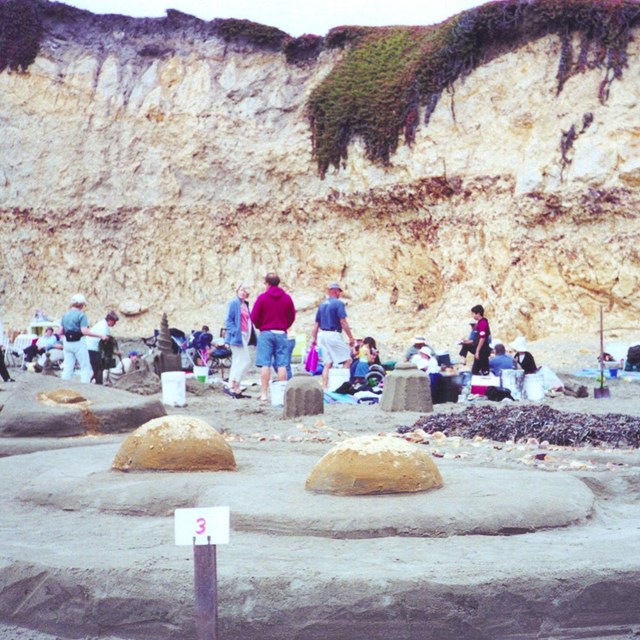 A sand sculpture of two eggs cooked sunny-side up.
