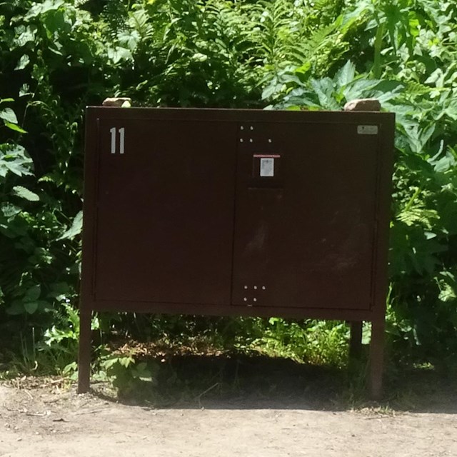 A large brown metal food storage locker.