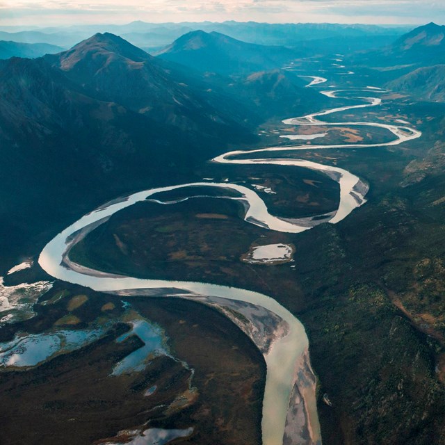a winding river through a mountain valley