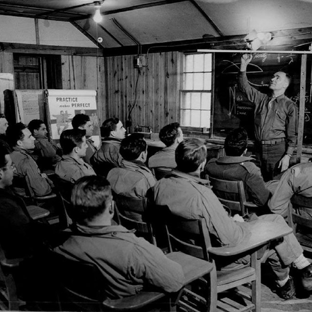 Group of OSS trainees taking a course in one of the cabin camps