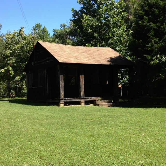 Cabin in Cabin Camp 2 surrounded by a large open field and trees