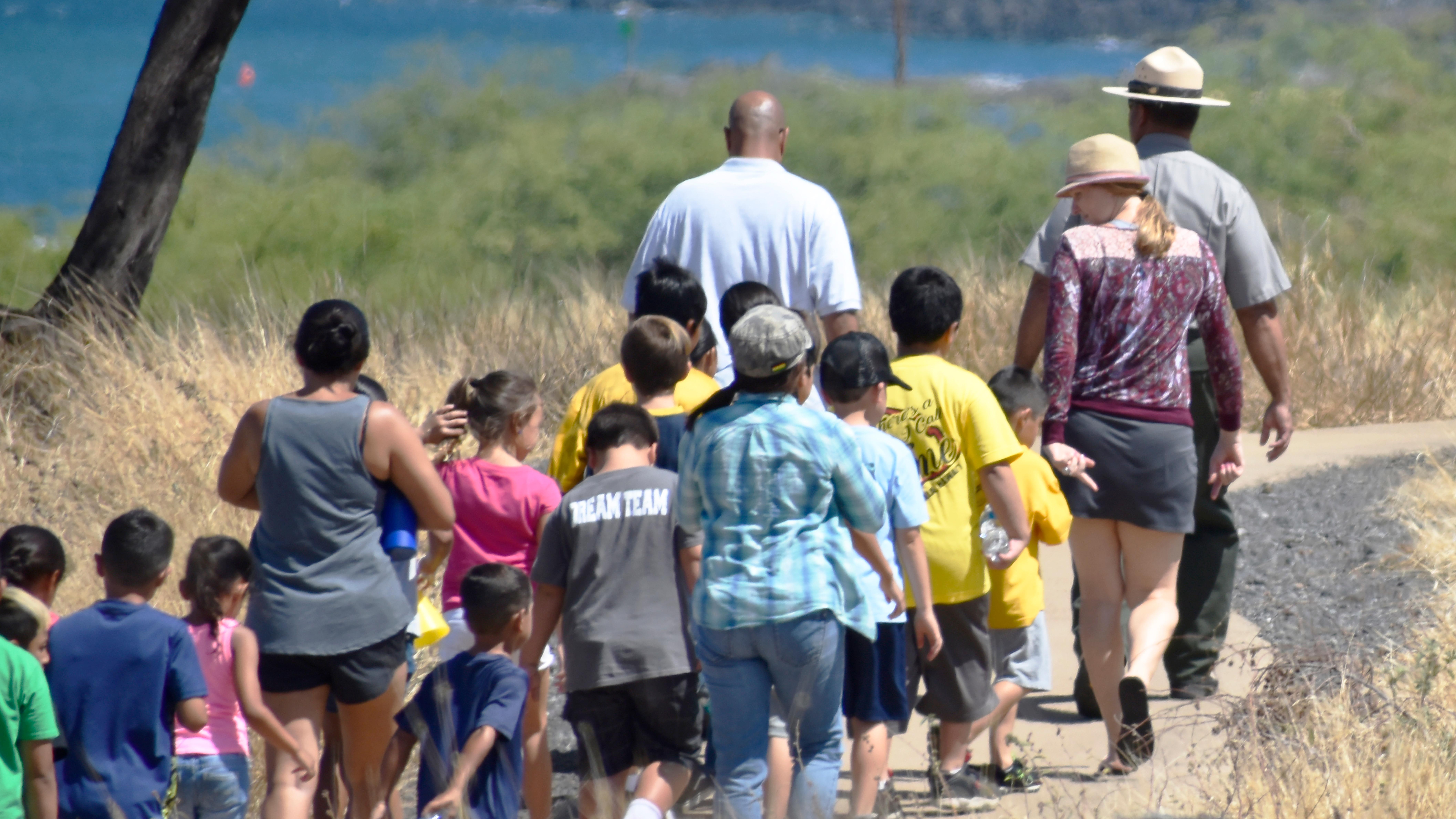 Park ranger leading group of kids along the trail