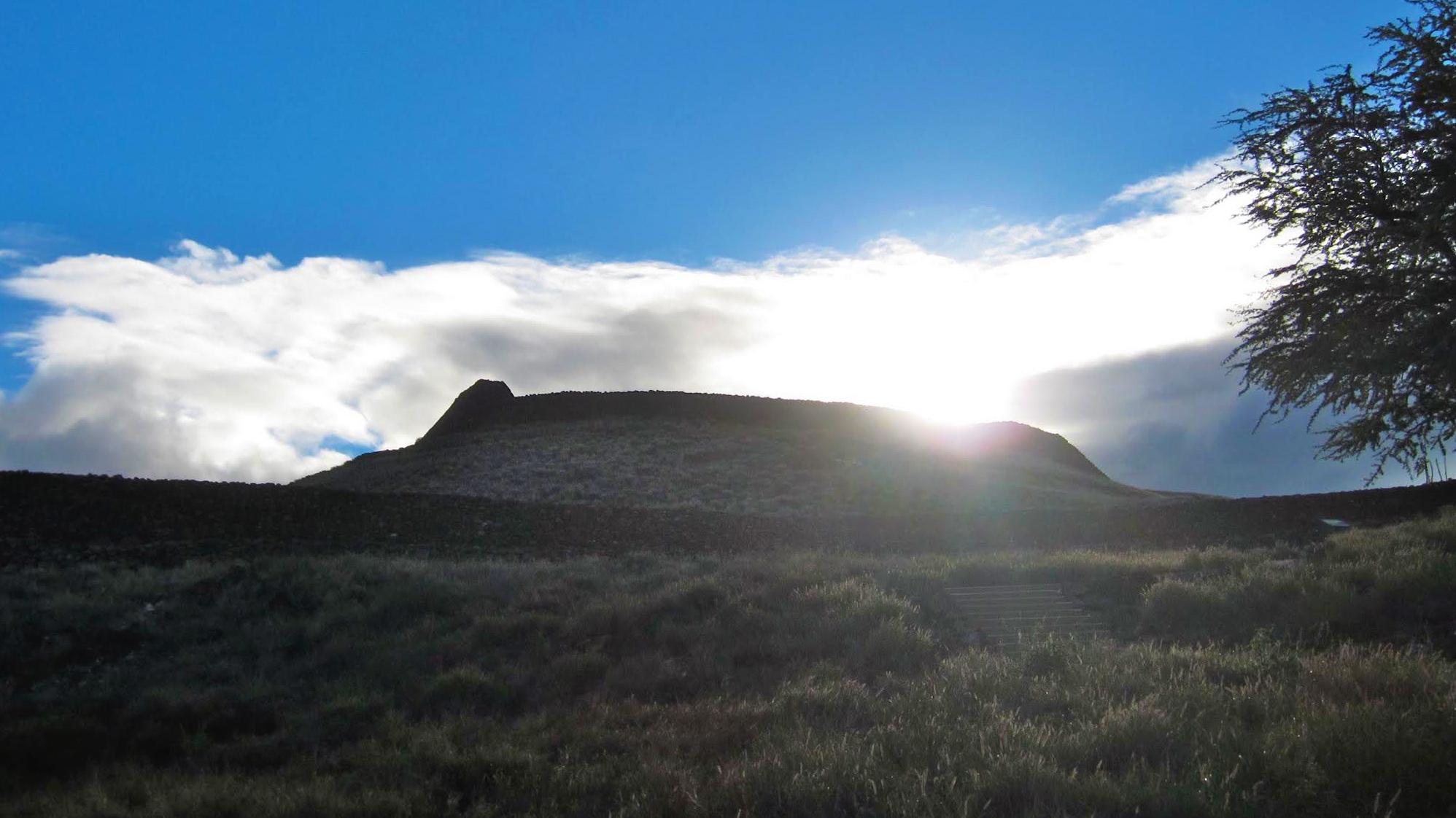 Sun rising over heiau