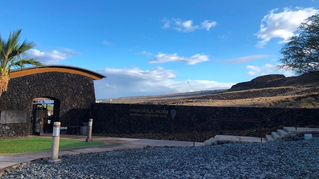 View of entrance to the Visitor Center, with a blue sky in the background.