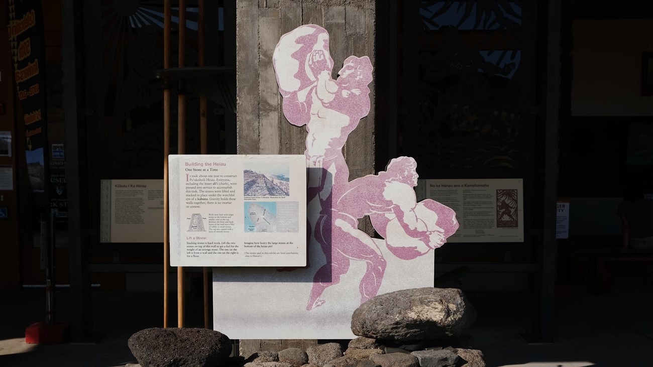Exhibit display of Hawaiian men stacking rocks