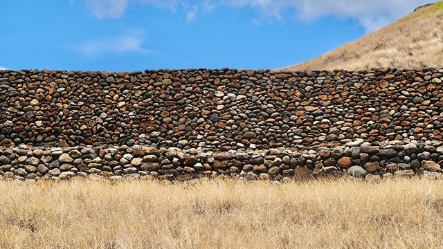 Close-up photograph of wall built of stacked rocks