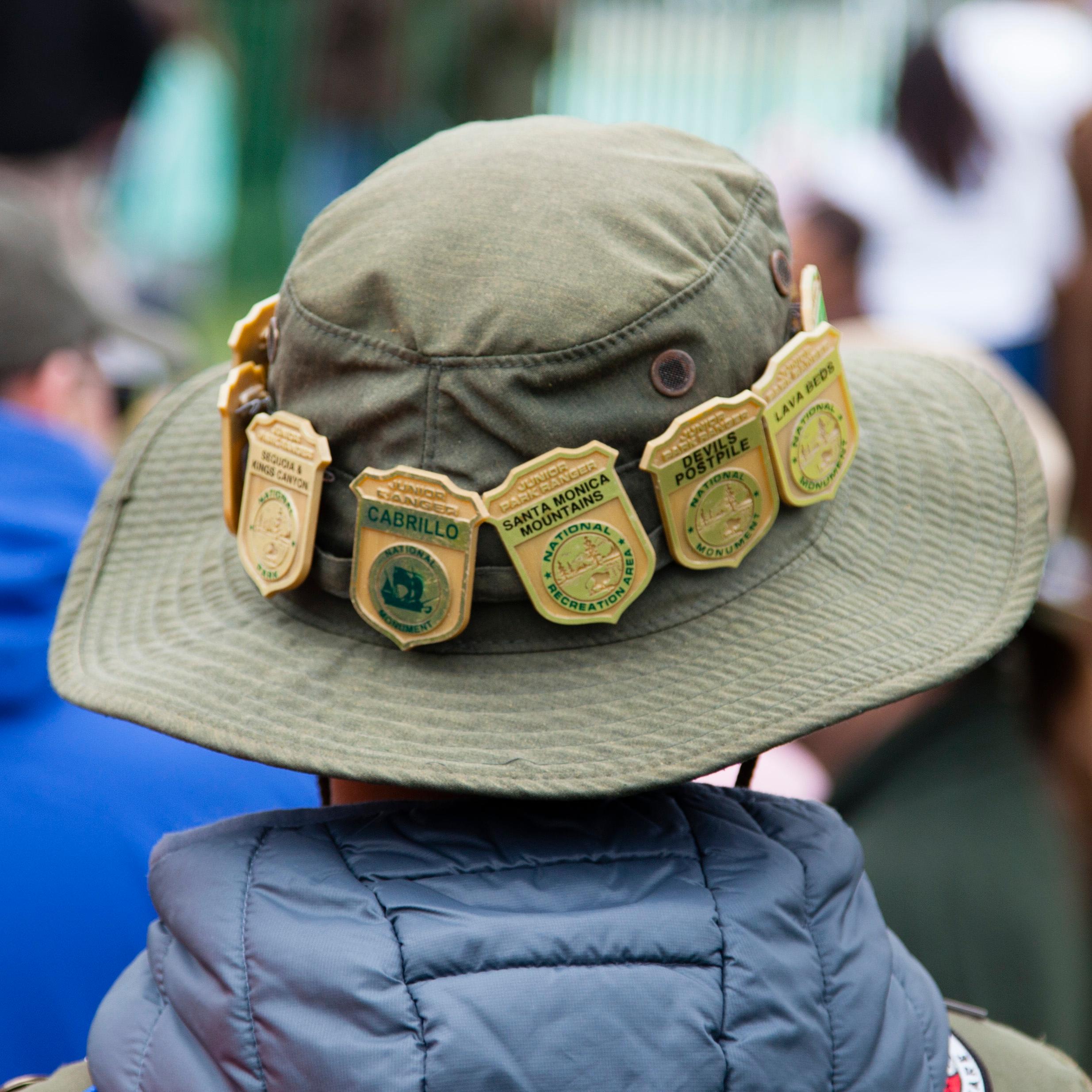 Junior Ranger badges line the brim of a child's Junior Ranger Hat.