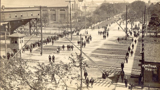 Photo of Pullman factory workers leaving the factory grounds, taken from above.