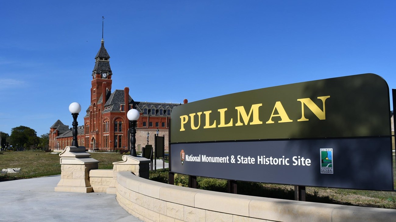 Pullman sign in front of the Administration Clock Tower building on a blue sky day.