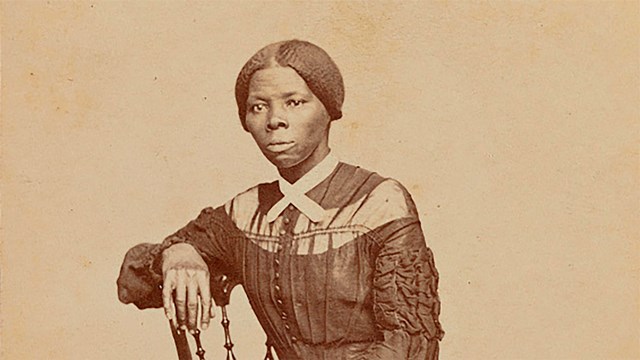 Harriet Tubman sitting in a chair looking straight forward.