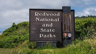 The park entrance sign on a cloudy day.