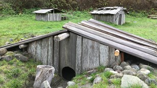 Yurok village buildings made of redwood planks.