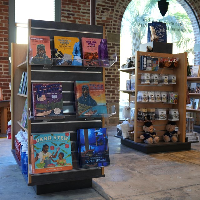 Three shelves full of merchandise set up in a building.