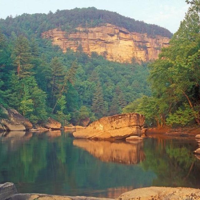 The Big South Fork River is framed against the sheer cliffs of the river gorge.
