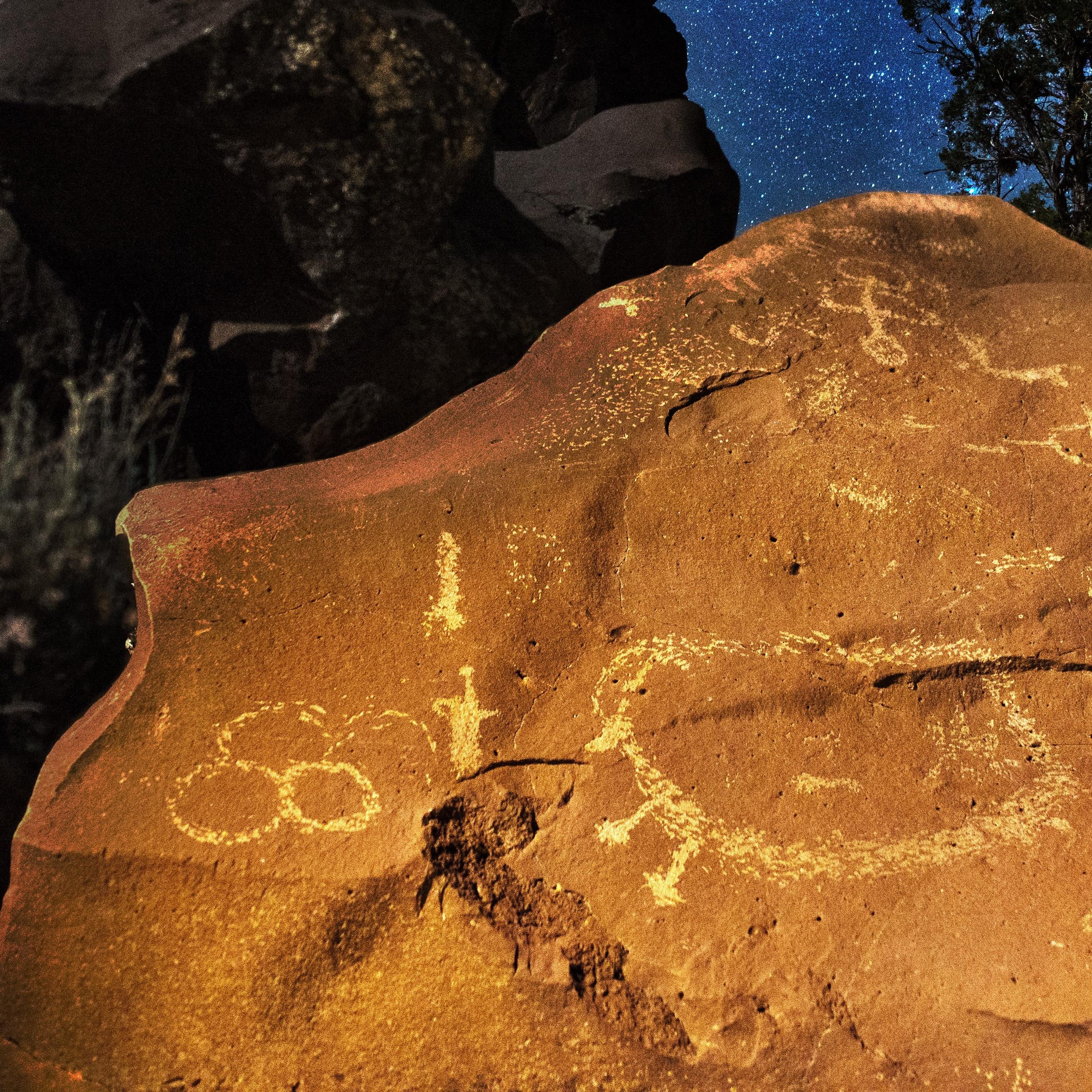 night sky behind rock with petroglyphs