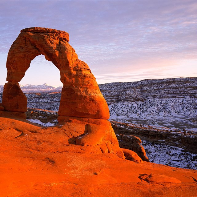 red rock arch with blue sky