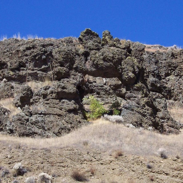rock outcroppings with dry brown grass in foreground