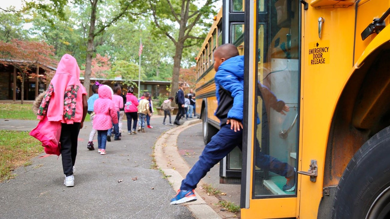 Stdents getting off of a bus outside the Rock Creek Park Nature Center