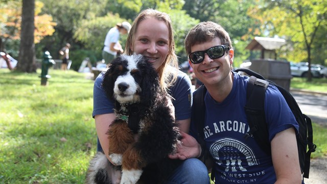 Visitors hugging their dog
