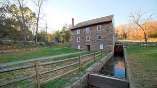 Peirce Mill from behind, the water wheel trough leads up to the building.