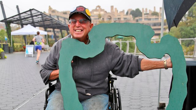 A man in a wheelchair visits Rock Creek Park Day. 