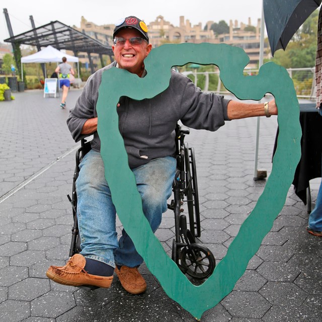 A man in a wheelchair visits Rock Creek Park Day. 