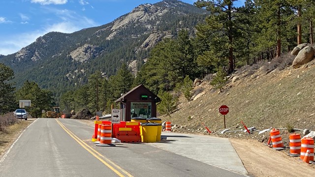 The Fall River Entrance to RMNP is under construction. Orange cones line the lane to the kiosk.
