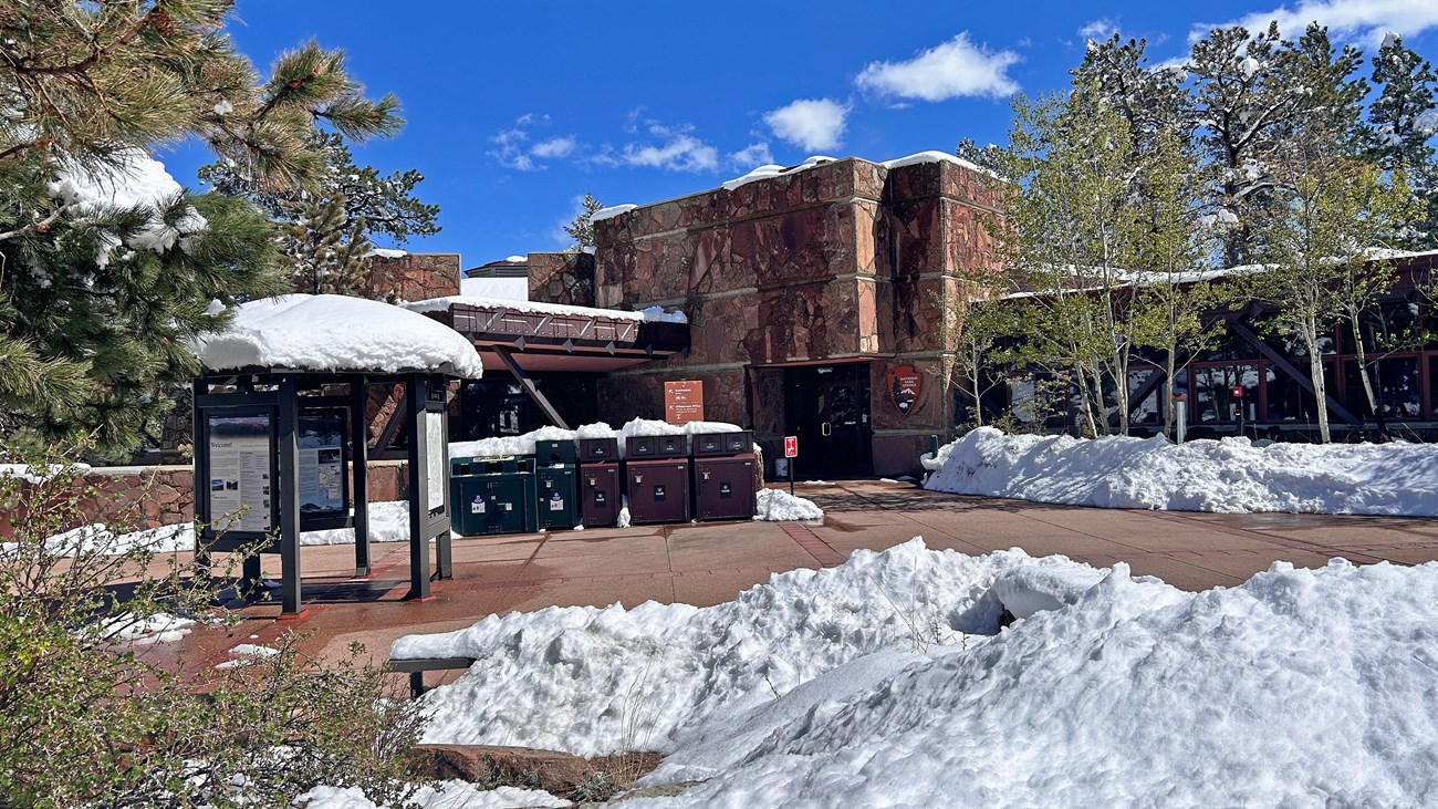 Entrance to Beaver Meadows Visitor Center during a spring snowstorm