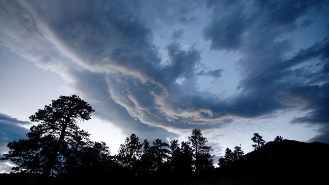 Stormy clouds gather over the rocky mountains