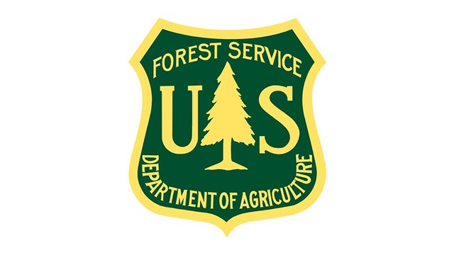 US Forest Service Logo - green badge with tree.