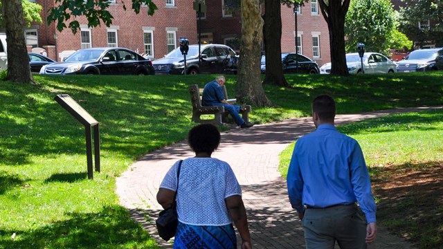 View of the parks greenery with people walking through the park