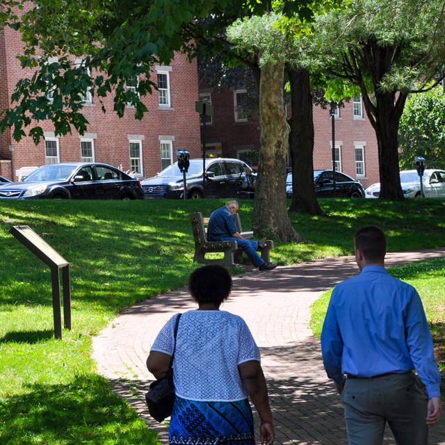 View of the parks greenery with people walking through the park