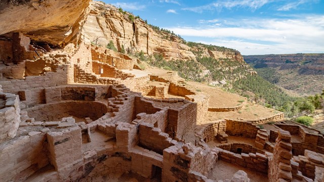 Mesa Verde National Park’s Long House Cliff Dwelling Kivas on a sunny day with the cliff shadowing t