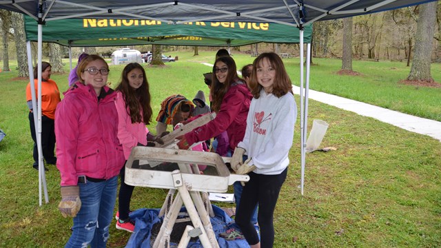 Girl scouts sift dirt to find artifacts