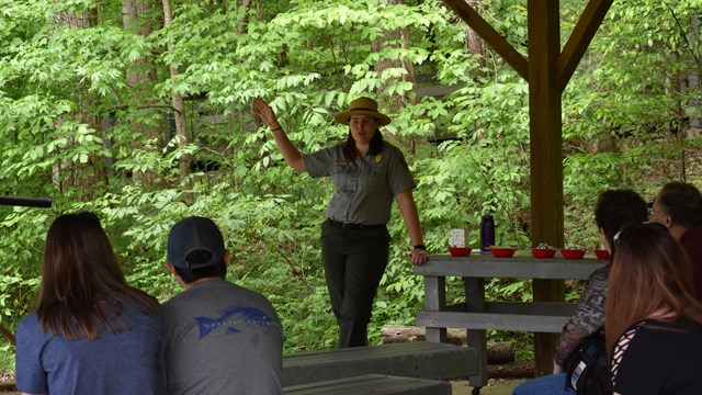 Ranger talks to group of visitors outside