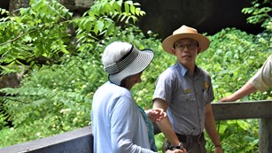 A ranger talks to a visitor outside
