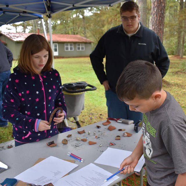 Visitors learning about artifacts