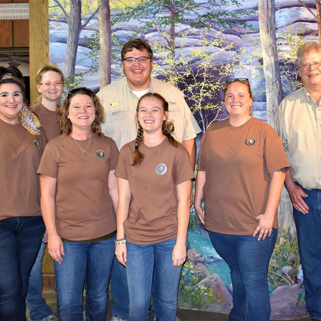 Seven Volunteers pose for a picture indoors