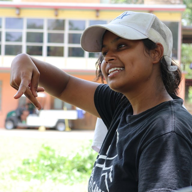 A person signs a letter P in ASL.