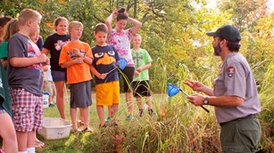 A ranger teaches a group of future Jr. Rangers