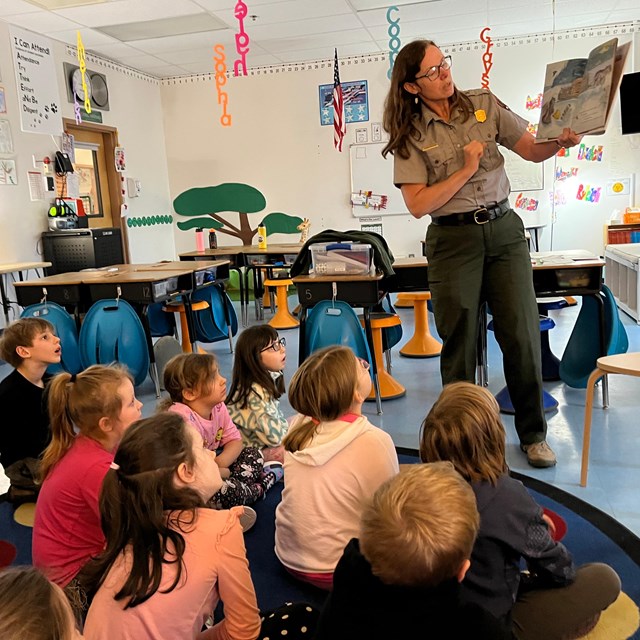 Ranger reading a book to students