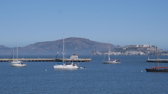 sailboats sit anchored in Aquatic Park Cove