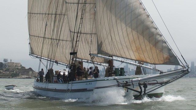 Sailing vessel on the water, flags flying in the wind