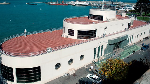 A building with a red roof and white sides.